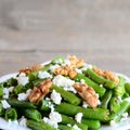 Easy green bean salad with cottage cheese and peeled walnuts. Tasty green beans recipe. Closeup Royalty Free Stock Photo