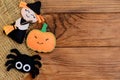 Easy Halloween crafts. Felt witch, pumpkin, spider ornaments on a wooden background with copy space for text