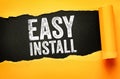 Easy Install text written on dark background through torn yellow paper. Concept of simple setup, quick assembly, and user-friendly Royalty Free Stock Photo