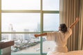 Easy lifestyle Asian woman waking up from good sleep in weekend morning taking some rest, relaxing in comfort bedroom at hotel Royalty Free Stock Photo