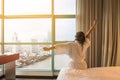Easy lifestyle Asian woman waking up in weekend morning taking some rest relaxing in comfort city hotel room Royalty Free Stock Photo