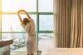 Easy lifestyle Asian woman waking up in weekend morning taking some rest relaxing in comfort city hotel room enjoying world lazy Royalty Free Stock Photo