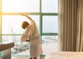 Easy lifestyle Asian woman waking up in weekend morning taking some rest relaxing in comfort city hotel room enjoying world lazy Royalty Free Stock Photo