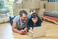 An easy moving day is a planned out one. a husband and wife using a laptop together on moving day. Royalty Free Stock Photo