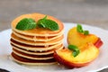 Everyday pancakes with syrup and grilled fruit on a serving plate. Pancake recipe without baking powder. Breakfast idea Royalty Free Stock Photo