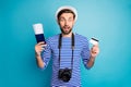 Easy payment. Photo of crazy shocked guy photographer hold digital camera traveler buy tickets with help of credit card