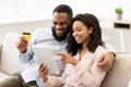 Black couple using tablet and debit credit card at home Royalty Free Stock Photo