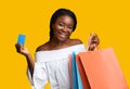Easy Payments. Smiling Black Young Woman Holding Credit Card And Shopping Bags Royalty Free Stock Photo