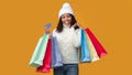 Smiling black lady holding credit card and shopping bags Royalty Free Stock Photo