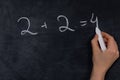 An Easy and Simple Arithmetic Problem Shown on a Classroom Chalkboard for Kids to Solve Royalty Free Stock Photo