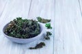 Easy three ingredient baked green kale chips with sea salt and olive oil, in gray bowl, horizontal, copy space