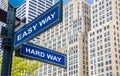 Easy way, hard way crossroads street sign. Highrise buildings background Royalty Free Stock Photo