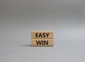 Easy win symbol. Wooden blocks with words Easy win. Beautiful grey background. Business and Easy win concept. Copy space