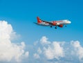 Easyjet Airbus A320 flying by in white clouds and blue sky, landing at Larnaca International Airport Royalty Free Stock Photo