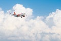 Easyjet Airbus A320 flying by in white clouds and blue sky, landing at Larnaca International Airport Royalty Free Stock Photo