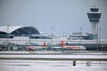 EasyJet and Alitalia planes at terminal gates in Munich Airport, snow