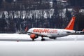 Easyjet landing in Innsbruck Airport, INN, snow in winter Royalty Free Stock Photo