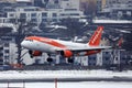 Easyjet landing in Innsbruck Airport, INN, snow in winter Royalty Free Stock Photo