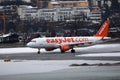 Easyjet landing in Innsbruck Airport, INN, snow in winter Royalty Free Stock Photo