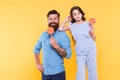 Eat dessert first. Happy family hold candy dessert on stick. Father and daughter yellow background. Bearded man and