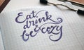 Eat, drink and be cozy calligraphic background