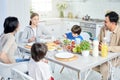 Eat and enjoy. Happy latin family enjoying meal together, sitting at the table in kitchen at home Royalty Free Stock Photo