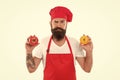 Eat fresh tomato. Healthy cooking concept. Man with beard isolated on white. professional cook in uniform prepare fresh Royalty Free Stock Photo