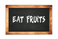 EAT FRUITS text written on wooden frame school blackboard