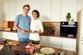 Eat green. Smiling couple, vegetarians cooking breakfast in the kitchen together. Young man and woman preparing healthy