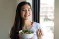 Eat healthy food on wellness lifestyle. Beauty young woman eating salad as a breakfast. Royalty Free Stock Photo