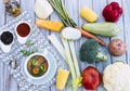 Eat healthy with fresh, ready-to-eat homemade vegetable soup. Raw vegetables on the wooden table, olive oil and croutons Royalty Free Stock Photo