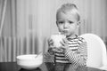 Eat healthy. Toddler having snack. Healthy nutrition. Drink milk. Child hold glass of milk. Kid cute boy sit at table Royalty Free Stock Photo