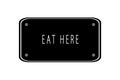 Eat Here written on a blackboard on a white background Royalty Free Stock Photo
