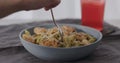 eat penne pasta served with shrimps in blue bowl closeup Royalty Free Stock Photo