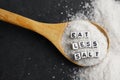 Eat less salt in order to reduce blood pressure or hypertension risk with sprinkled salt on dark background Royalty Free Stock Photo