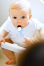 Eat smeared baby in chair feeding by mother