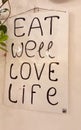 Eat well love life text on a ceramic near to an italian restaurant Royalty Free Stock Photo