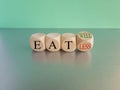 Eat well or less symbol. Turned a cube and changed red words eat less to eat well. Beautiful blue background. Business, eat well