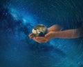 earth globe in hands on front blue starry sky nebula hold world peace concept nature background