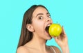 Eating apple. Portrait of woman eating green apple. Smiling woman with healthy teeth holding green apples. Healthy diet