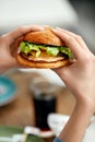 Eating Burger. Woman Holding Hamburger In Hands