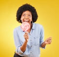 Eating, candy and lollipop with black woman in studio for colorful, cheerful and positive. Young, happiness and dessert