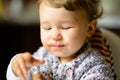 Eating cheerful baby girl with messy face Royalty Free Stock Photo