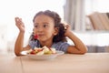 Eating child, breakfast and fruit salad at home with happiness and wellness meal with a smile. House, nutrition and