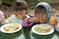 Eating children during food distribution Royalty Free Stock Photo