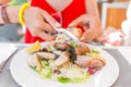 eating crab claw using special pliers tool to reach for delicious white meat. Spanish mediterranean seafood cuisine concept