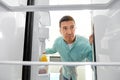 Man looking for food in empty fridge at kitchen Royalty Free Stock Photo