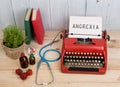 Eating disorder concept - typewriter with text Anorexia, blue stethoscope, pills, red typewriter, strawberries Royalty Free Stock Photo