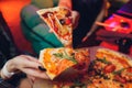 Eating Food. Close-up Of People Hands Taking Slices Of Pepperoni Pizza. Group Of Friends Sharing Pizza Together. Fast Royalty Free Stock Photo