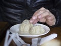 Eating with hands poses - traditional Buryat food Royalty Free Stock Photo